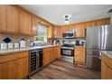 Bright kitchen featuring custom wood cabinetry, stainless steel appliances, and modern countertops at 903 Dixie Maid Ln, Valrico, FL 33594