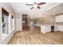 Spacious living room featuring wood floors, large windows, and an open staircase, creating a bright and airy atmosphere at 932 Woodbridge Ct, Safety Harbor, FL 34695