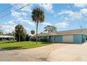 Inviting light blue single-story home with a spacious driveway and lush front lawn, a true gem at 105 E North Branch Rd, Ruskin, FL 33570