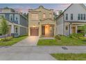 Inviting home featuring a well-manicured lawn, covered porch, and a charming two-story design with a private garage at 115 W Hiawatha St, Tampa, FL 33604