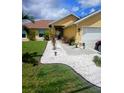 Charming single-story home features a pristine walkway and lush landscaping, enhancing its curb appeal at 1185 Rio De Janeiro Ave, Punta Gorda, FL 33983