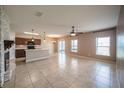 Open-concept living area featuring tile flooring, ample natural light, and a kitchen with stainless steel appliances at 14524 Dunrobin Dr, Wimauma, FL 33598
