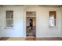 View of the main living area showing hardwood floors, two windows and passage to another room at 1520 S Michigan Ave, Clearwater, FL 33756