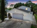 Charming two-story home featuring an attached two car garage and a beautiful landscaped front yard at 15722 Gardenside Ln, Tampa, FL 33624