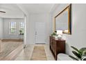 Bright foyer with tile flooring, large mirror, console table, and view to the living area at 1827 Trillium Blvd, Brooksville, FL 34604