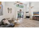 Bright living room with vaulted ceilings, fireplace, and sliding glass doors to the lanai at 1830 Cypress Trace Dr, Safety Harbor, FL 34695