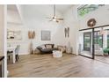 Open living space with vaulted ceilings, light wood floors, and natural light from large windows at 1830 Cypress Trace Dr, Safety Harbor, FL 34695