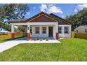 Beautiful home boasting a cozy front porch, neatly arranged landscaping, and architectural details at 1914 E Chelsea St, Tampa, FL 33610