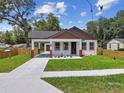 Inviting home with a covered carport, fresh landscaping, and a well-maintained front yard at 1914 E Chelsea St, Tampa, FL 33610