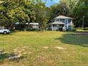 Well-maintained front yard with lush green grass and a charming two-story house in the background at 222 Spring Lake Hwy, Brooksville, FL 34602