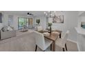 Bright living room boasts modern furnishings, a sliding glass door, and scenic outdoor views at 2681 Sabal Springs Cir # 204, Clearwater, FL 33761