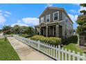 Street view showcasing a well-manicured front yard with white picket fence enhancing this two story homes curb appeal at 2706 Lantern Hill Ave, Brandon, FL 33511