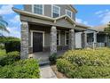 Inviting front porch featuring stone pillars and manicured landscaping, offering a warm welcome at 2706 Lantern Hill Ave, Brandon, FL 33511