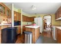 Functional kitchen with wood cabinets, white appliances, and center island providing a practical cooking space at 4537 Thornton Dr, Zephyrhills, FL 33542