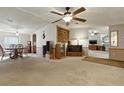 Spacious living room with ceiling fan, carpeted floor and classic decor offering a cozy atmosphere at 4537 Thornton Dr, Zephyrhills, FL 33542