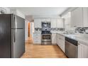 Modern kitchen with stainless steel appliances, granite countertops, and tiled backsplash at 5414 Oceanic Rd, Holiday, FL 34690