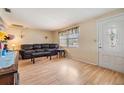 Comfortable living room with laminate floors, natural light, and a cozy atmosphere at 5414 Oceanic Rd, Holiday, FL 34690