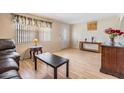 Inviting living area featuring laminate floors, natural light, and traditional decor at 5414 Oceanic Rd, Holiday, FL 34690