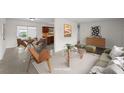 Bright living room featuring stylish furniture, neutral tones, and views into dining and kitchen at 5627 57Th N Ave, St Petersburg, FL 33709