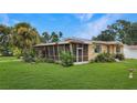 A yellow, single-story home with a screened-in porch and a spacious, well-manicured lawn at 5631 23Rd S Ave, Gulfport, FL 33707