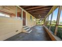 A large screened-in porch with a ceiling fan, concrete floor and wooden beams at 5631 23Rd S Ave, Gulfport, FL 33707