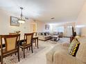 Bright living room and dining area with neutral tones, tile flooring, and comfortable seating at 5870 38Th N Ave # 44, St Petersburg, FL 33710
