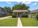 Charming single-story home with a well manicured lawn and inviting front porch at 6016 N Dexter Ave, Tampa, FL 33604
