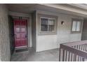 Exterior entrance to condo with a solid, secure red door at 6332 Newtown Cir # 32B2, Tampa, FL 33615