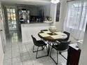 Cozy eat-in kitchen features neutral tile floor and ample natural light at 6781 121St Ave # H, Largo, FL 33773
