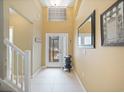 Bright entryway with high ceilings, tiled floors, neutral paint, and a glass-paneled door with a view of the outdoors at 8222 Haven Harbour Way, Bradenton, FL 34212