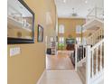 Inviting foyer with soaring ceilings, wood floors, an elegant staircase with white railings, and an upper level at 8222 Haven Harbour Way, Bradenton, FL 34212