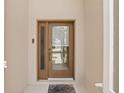 Close-up of a front door featuring a glass panel, a brown frame, and modern door hardware at 8222 Haven Harbour Way, Bradenton, FL 34212