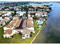 An aerial view of waterfront condos, a pool, a tennis court and beautiful ocean views at 1 Windrush Blvd # 84, Indian Rocks Beach, FL 33785