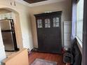The living area showcases wood floors, a decorative armoire, and is adjacent to the kitchen at 114 N Arcturas Ave, Clearwater, FL 33765