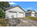 Detached two-car garage with white doors and ample parking space at 13991 Coronado Dr, Spring Hill, FL 34609