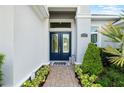 Home exterior of a beautiful brick paved path to the stunning double front door with glass windows at 15415 Otto Rd, Tampa, FL 33624