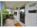 Inviting front porch with a classic rocking chair, brick accents, and a welcoming entrance at 1557 77Th N Ave, St Petersburg, FL 33702