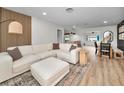 Bright living room features a large sectional sofa, modern decor, and hardwood flooring at 1557 77Th N Ave, St Petersburg, FL 33702