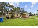 Inviting single-Gathering home features a neat lawn and classic design, set in a serene neighborhood under a beautiful sky at 1560 Connecticut Ne Ave, St Petersburg, FL 33703