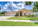 Charming single Gathering home with manicured lawn and three car garage at 17302 Stetson Ln, Odessa, FL 33556