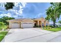 Charming single Gathering home with manicured lawn and three car garage at 17302 Stetson Ln, Odessa, FL 33556