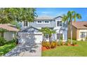 Beautiful two-story home with a well-maintained lawn and mature landscaping at 1734 Mapleleaf Blvd, Oldsmar, FL 34677