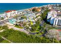 A beautiful aerial view of a property with beach access surrounded by tropical lush greenery at 19109 2Nd St, Indian Shores, FL 33785