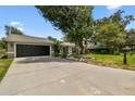 Charming single-story home featuring a well-manicured lawn and lush landscaping at 2 S Treasure Dr, Tampa, FL 33609
