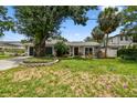 Charming single-story home featuring a well-manicured lawn and lush landscaping at 2 S Treasure Dr, Tampa, FL 33609