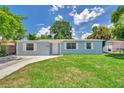Well-kept single-story home with lush green lawn, offering a cozy and welcoming curb appeal at 2509 W Crawford St, Tampa, FL 33614