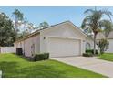 Attached two car garage showcasing its ample size and well-kept surroundings at 2625 Brookville Dr, Valrico, FL 33596