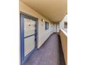 Hallway featuring carpet and exterior entrance to condo with natural light at 3062 Eastland Blvd # 308, Clearwater, FL 33761