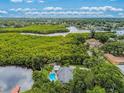 Aerial view showcasing the home's pool, landscaping, and waterfront location at 3225 Rosery Ne Rd, Largo, FL 33771