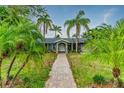 Charming front of house with beautiful landscaping and brick walkway at 3225 Rosery Ne Rd, Largo, FL 33771